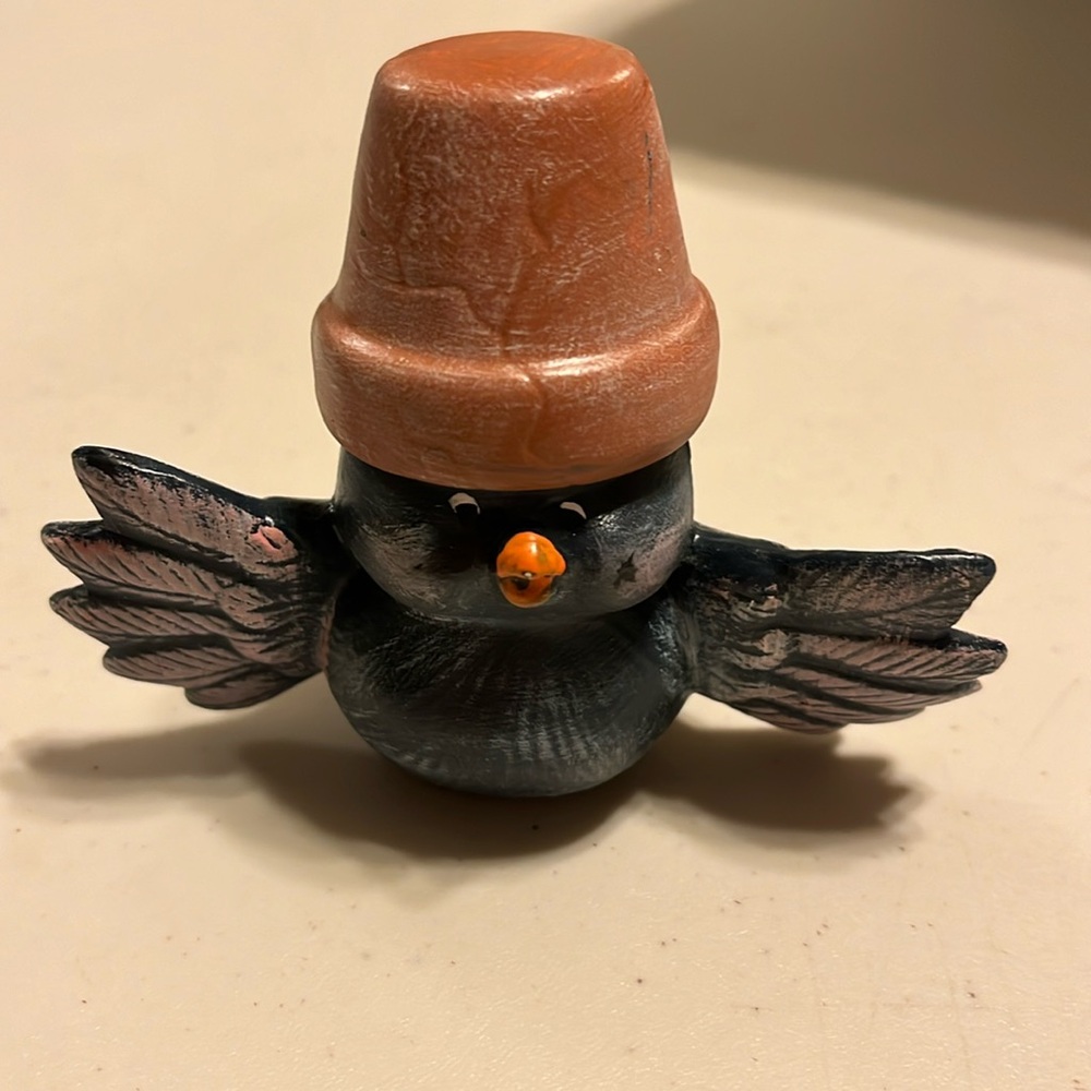ceramic chalk piece bird with a pot over his head